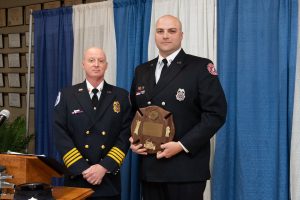 Chris Shaffer, Deputy Chief Career Division presents the Paramedic of the Year Award to Jeffrey Aperence.